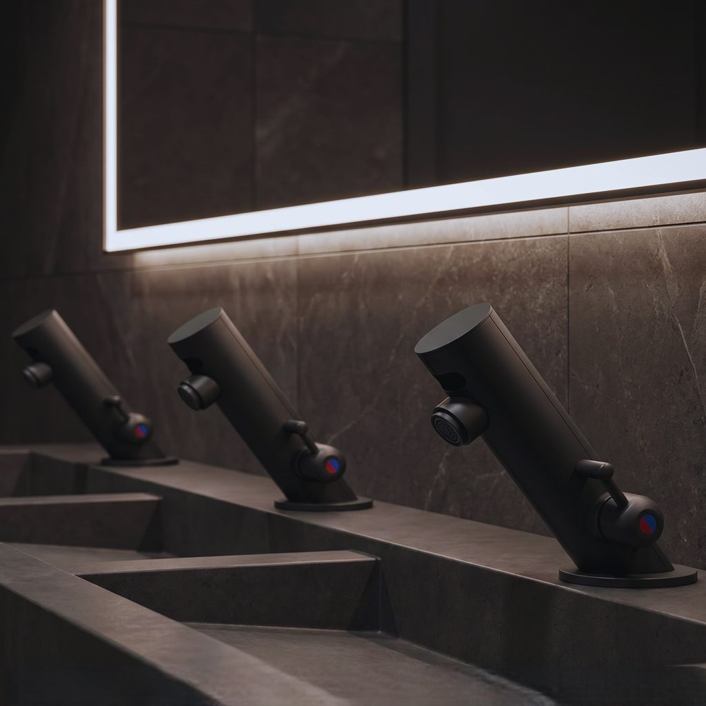 Commercial wall-mounted faucet and basin pairing illustrating spout reach, drain alignment, and splash-control coordination.