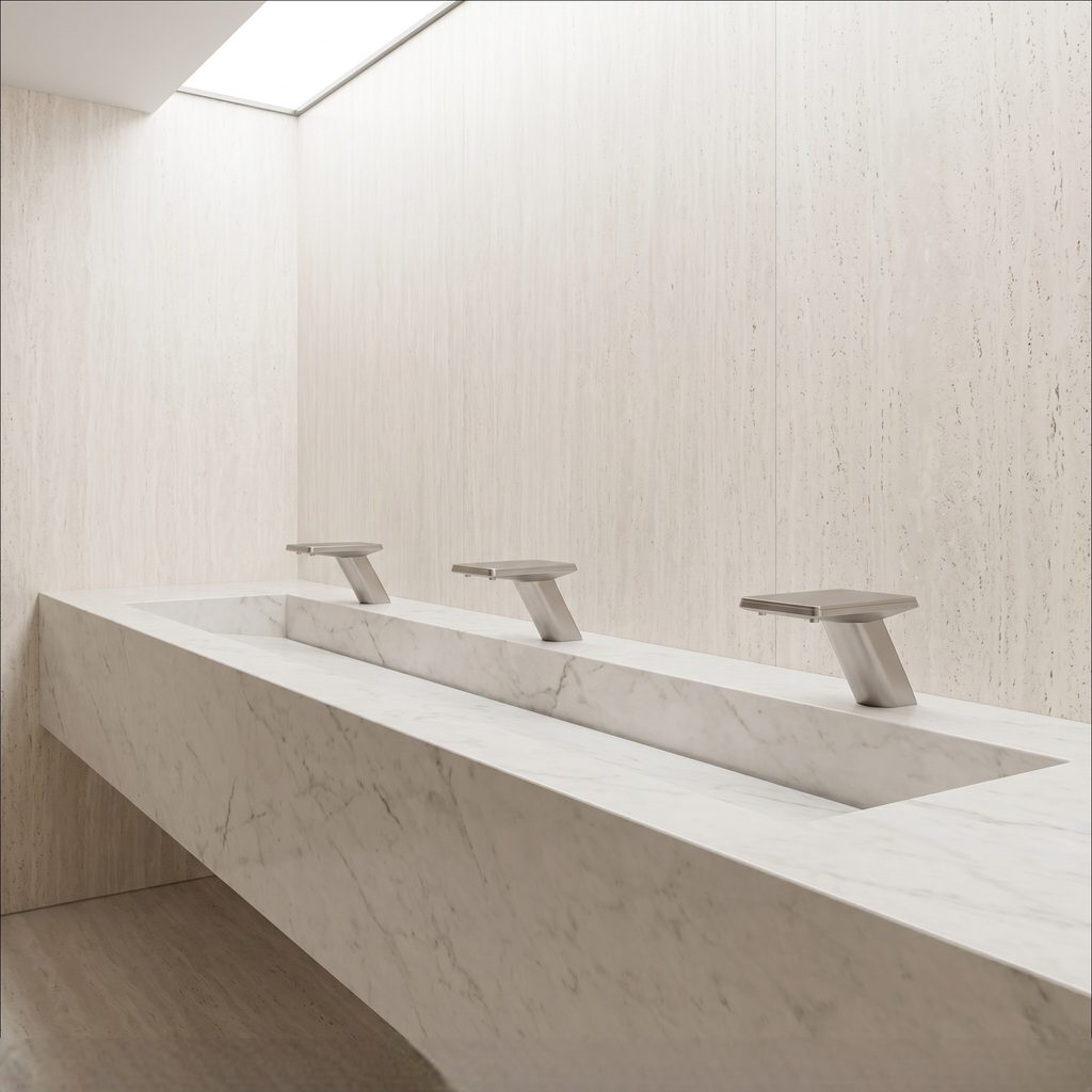 Commercial restroom with multiple deck-mounted touchless sensor faucets installed along a white trough basin