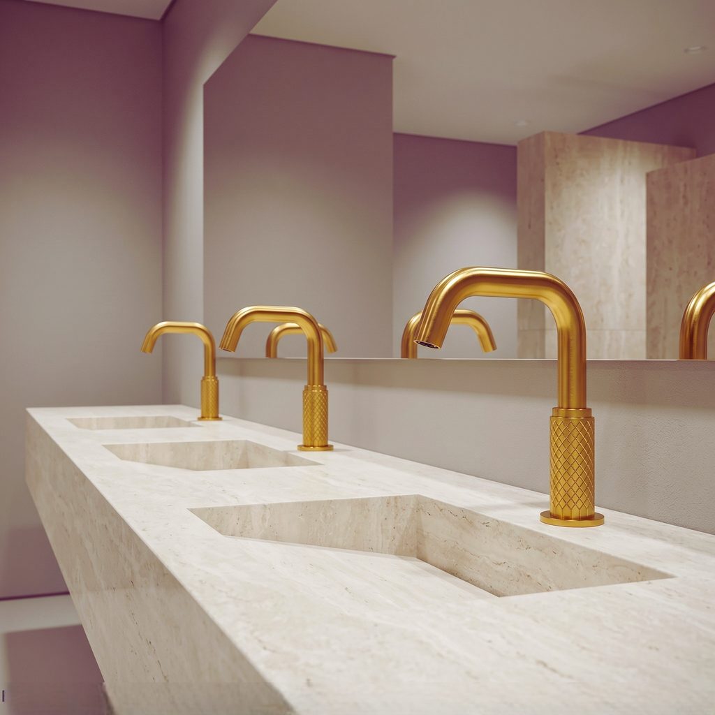 Gold bathroom faucet paired with a white marble countertop in a contemporary bathroom